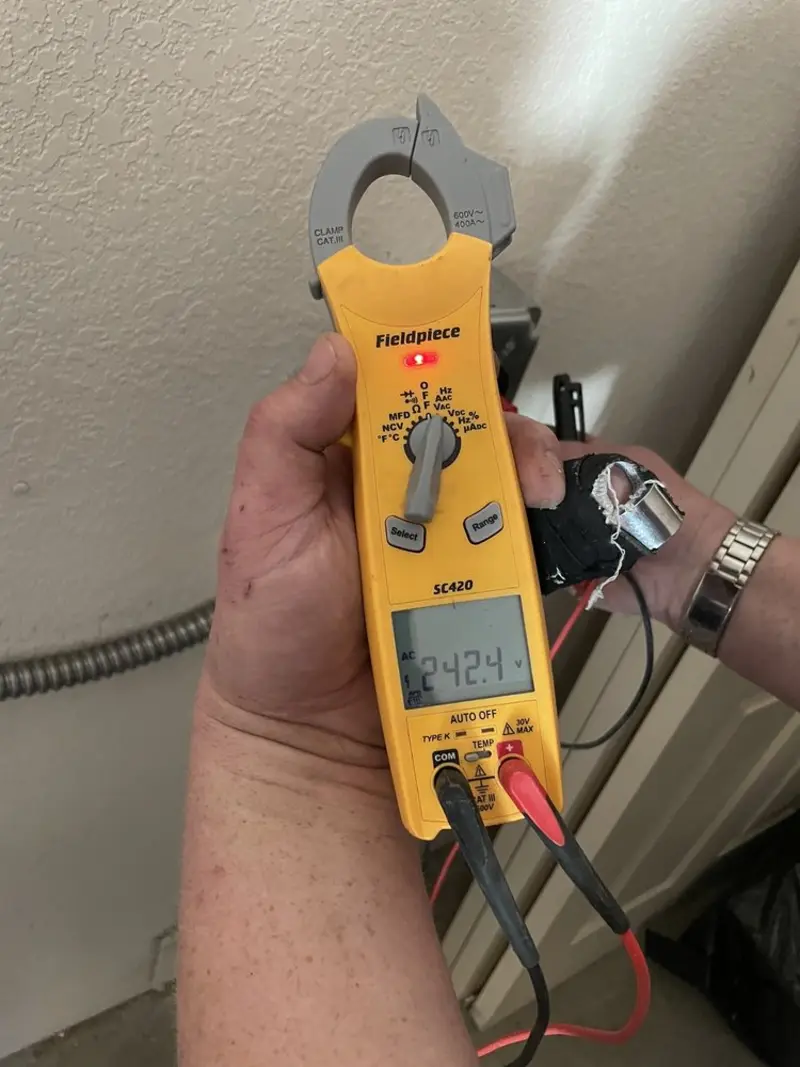 Voltage testing with clamp meter during Electrical Installation Services in El Dorado